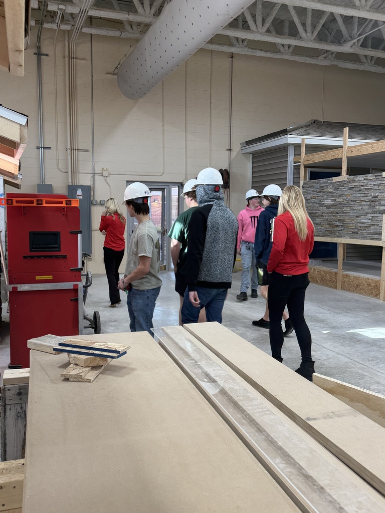 Students showing Michels representatives their work space.