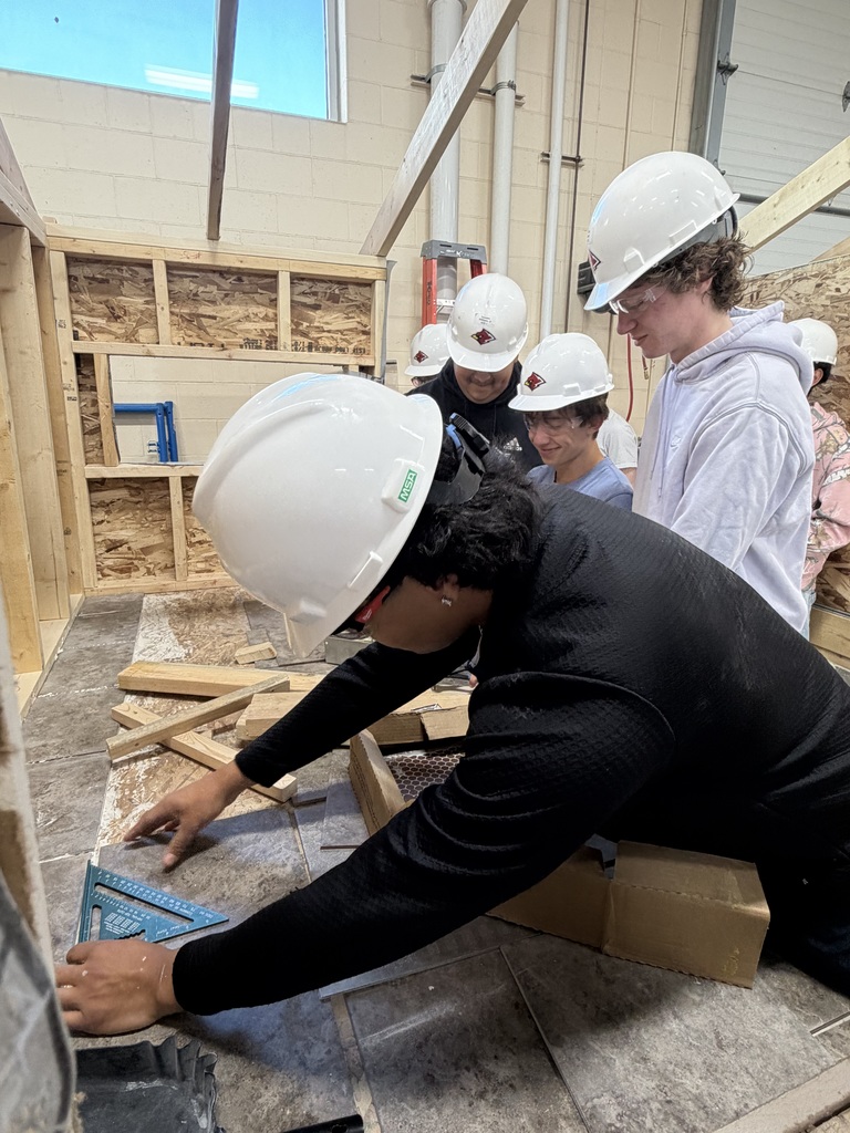 Students laying tile.