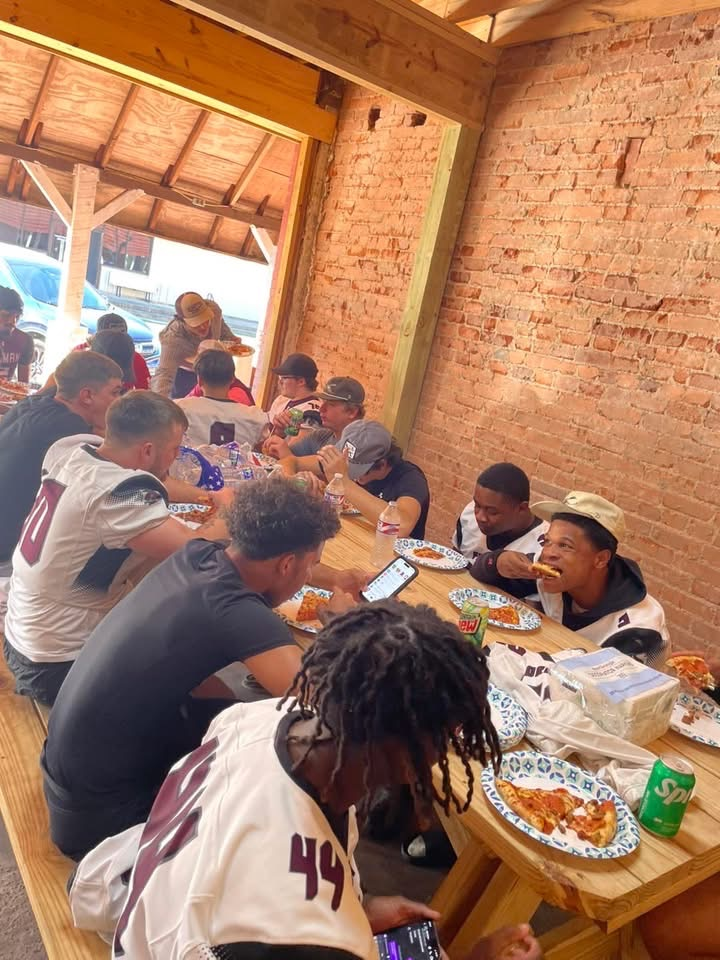 football boys eating pizza donated by Powered By Pies of Foreman, Arkansas
