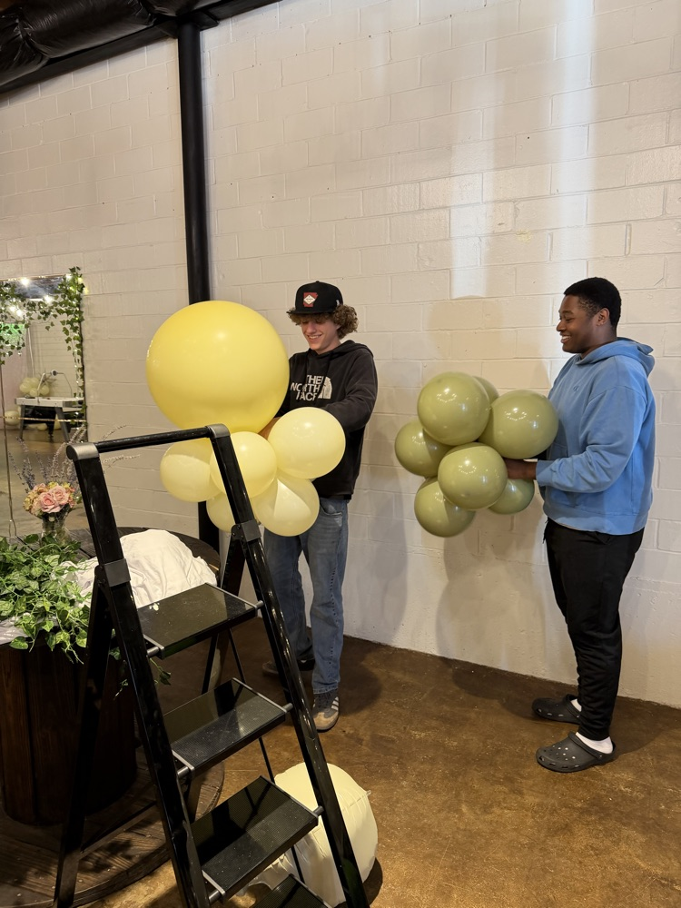 boys blowing up balloons