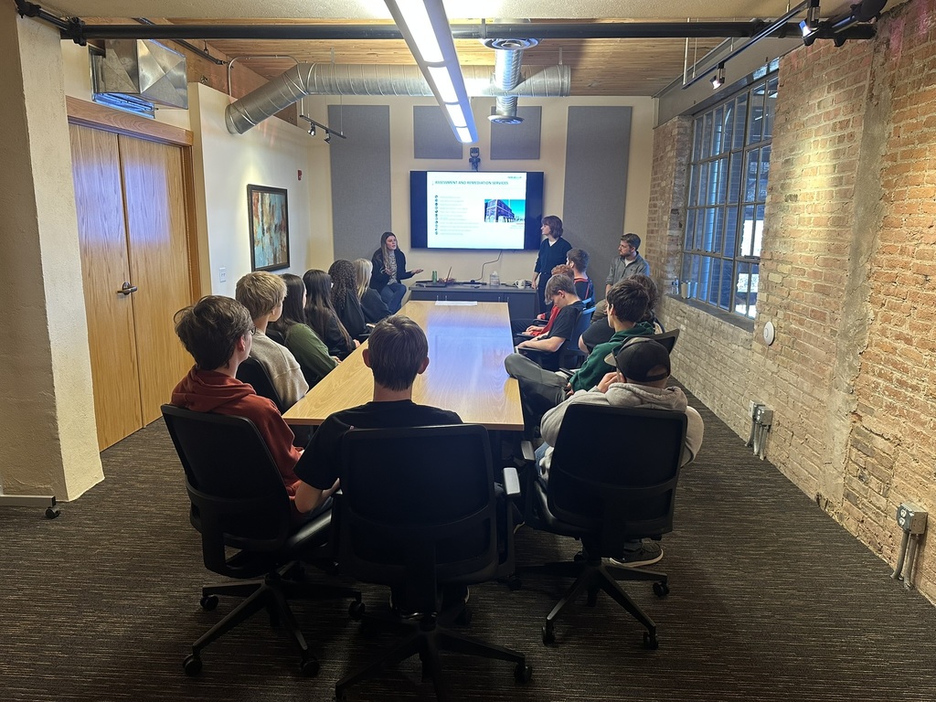 A Fehr Graham employee presenting to students about the services the firm provides.