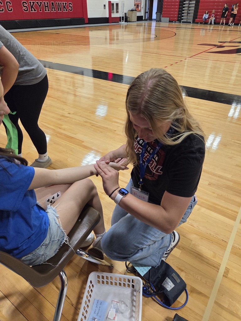 Student taking pulse of another student
