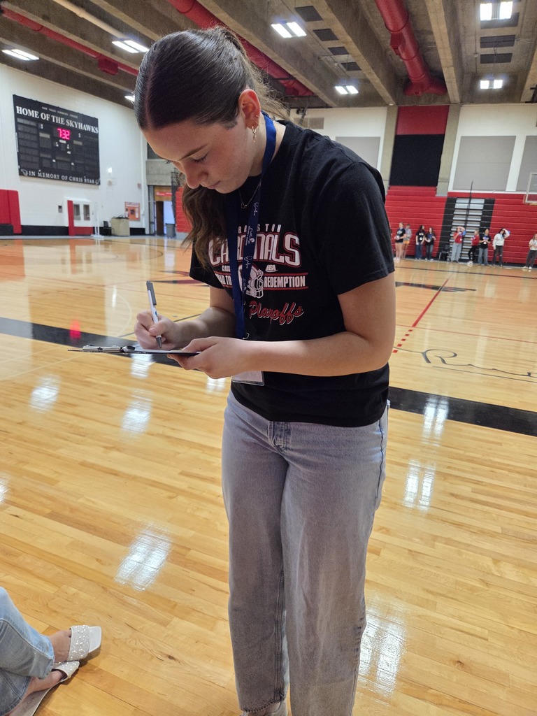 Student writing on clipboard