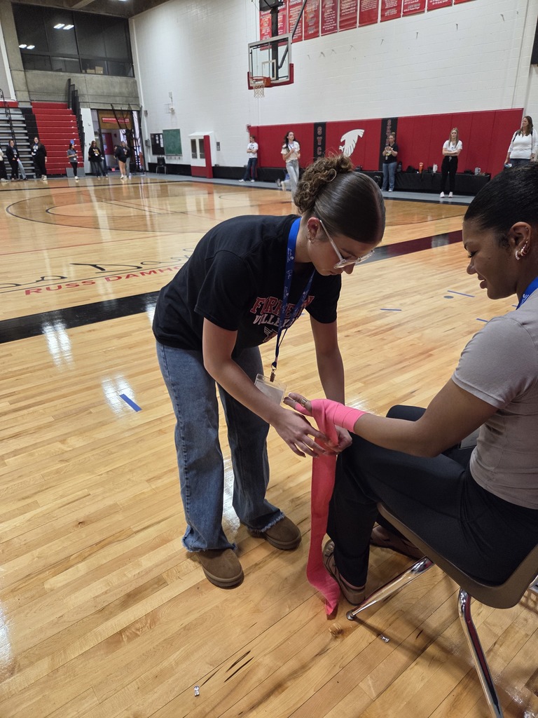 Student wrapping another students' wrist