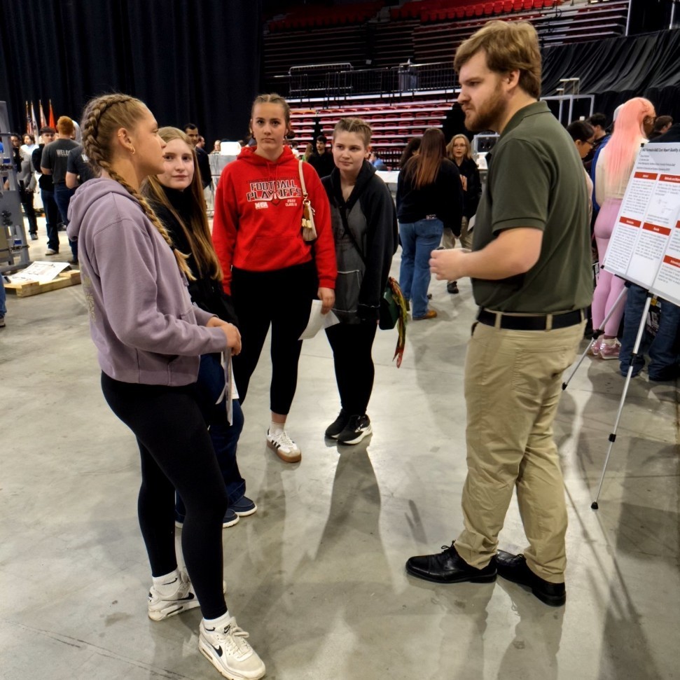 students asking an engineer about a design