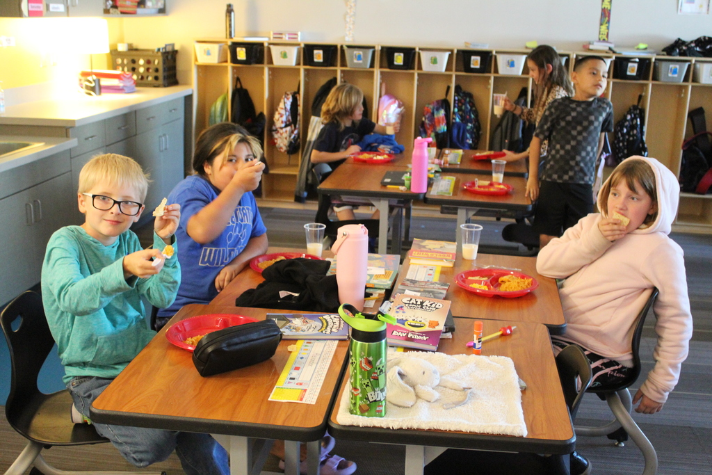 students at their desks with food