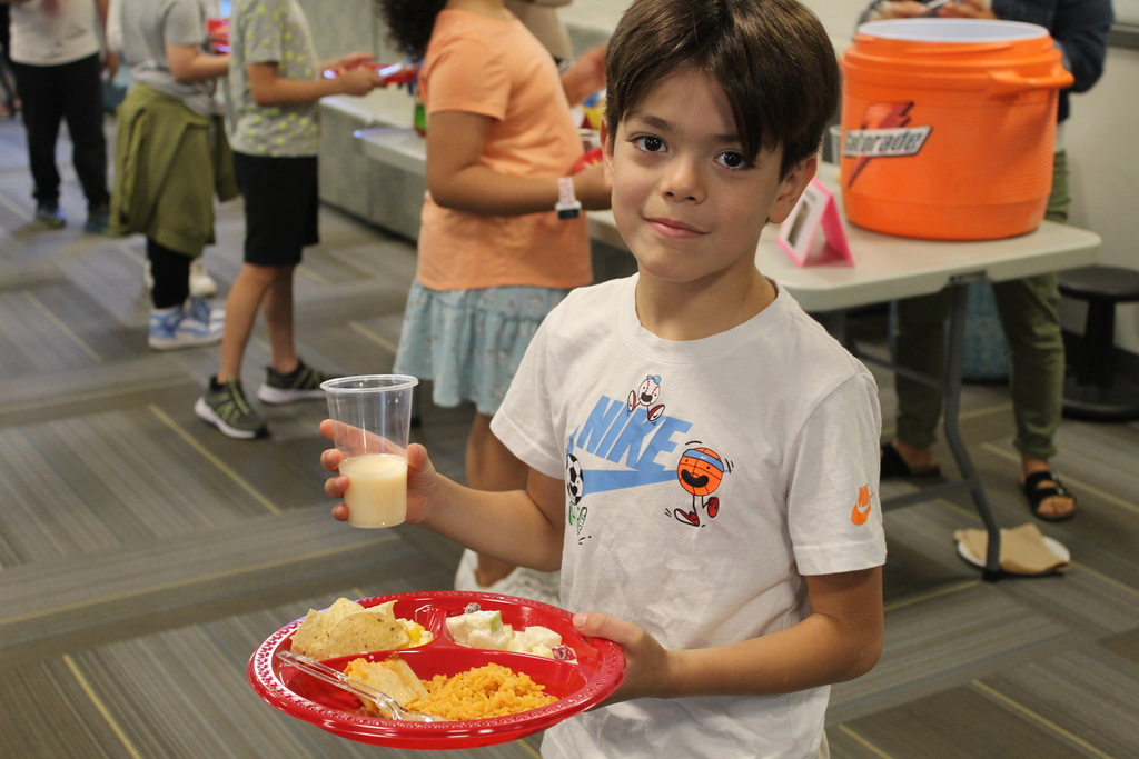 Student holding a plate of food