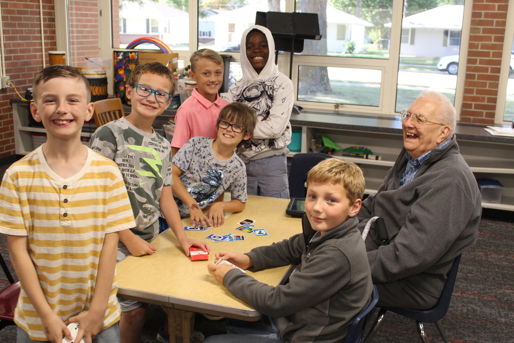 children smiling with an adult