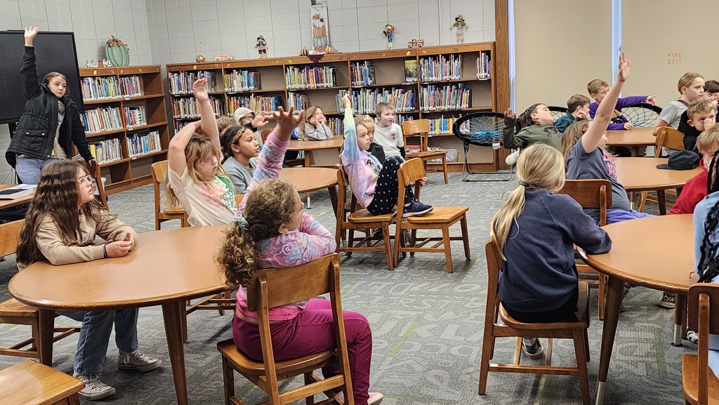students raising their hands