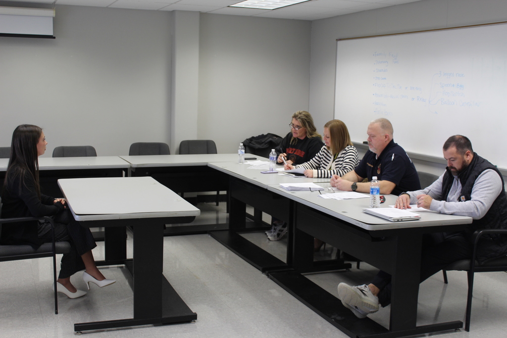 student being interviewed by panel of adults