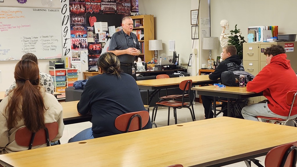 man talking to students
