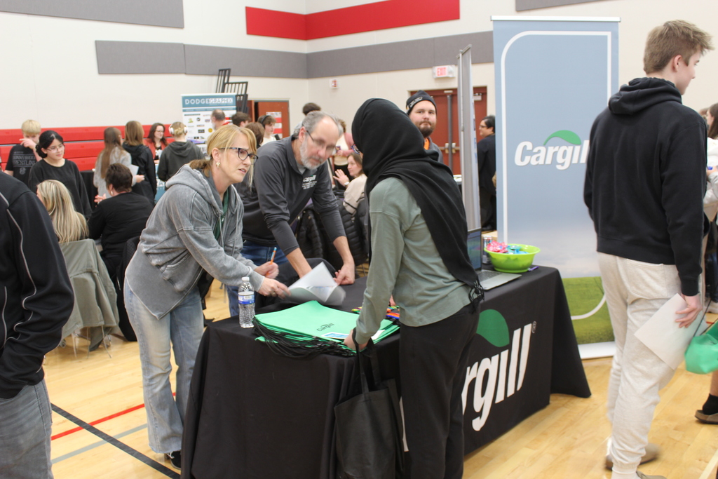 students talking to adult at career fair