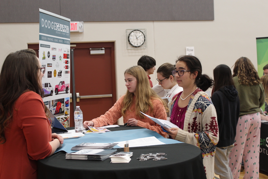 students talking to adult at career fair