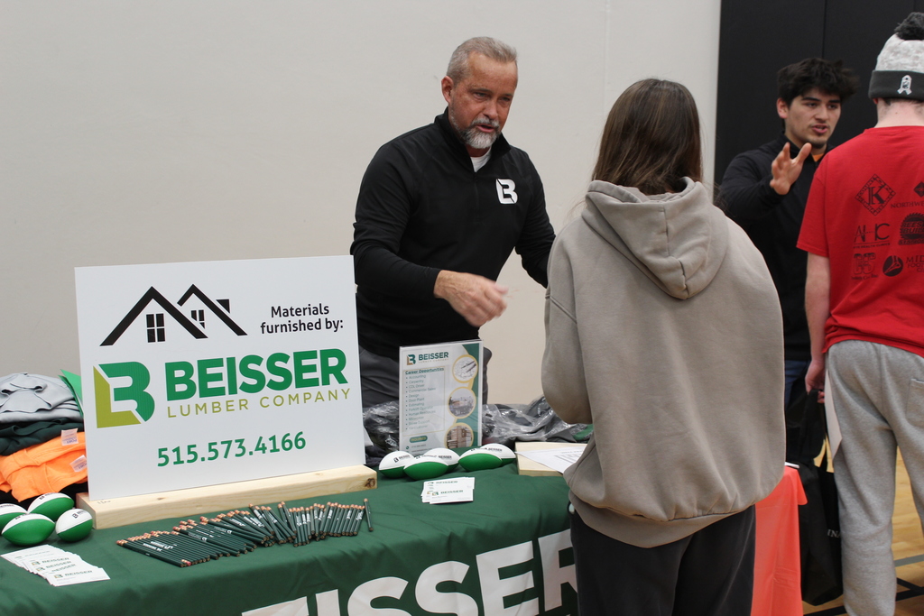 students talking to adult at career fair