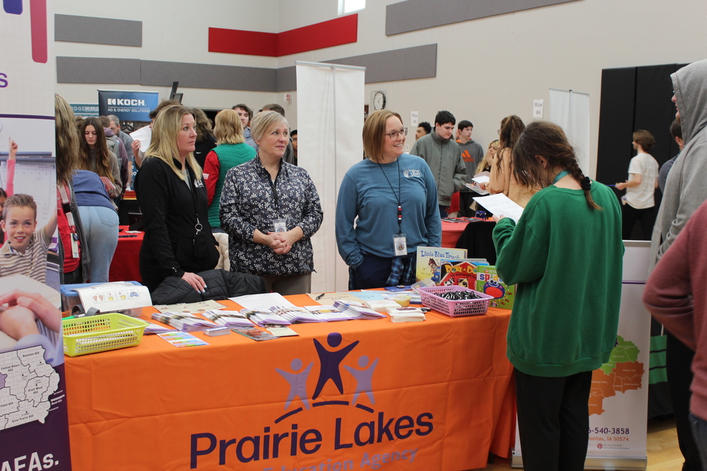 students talking to adult at career fair