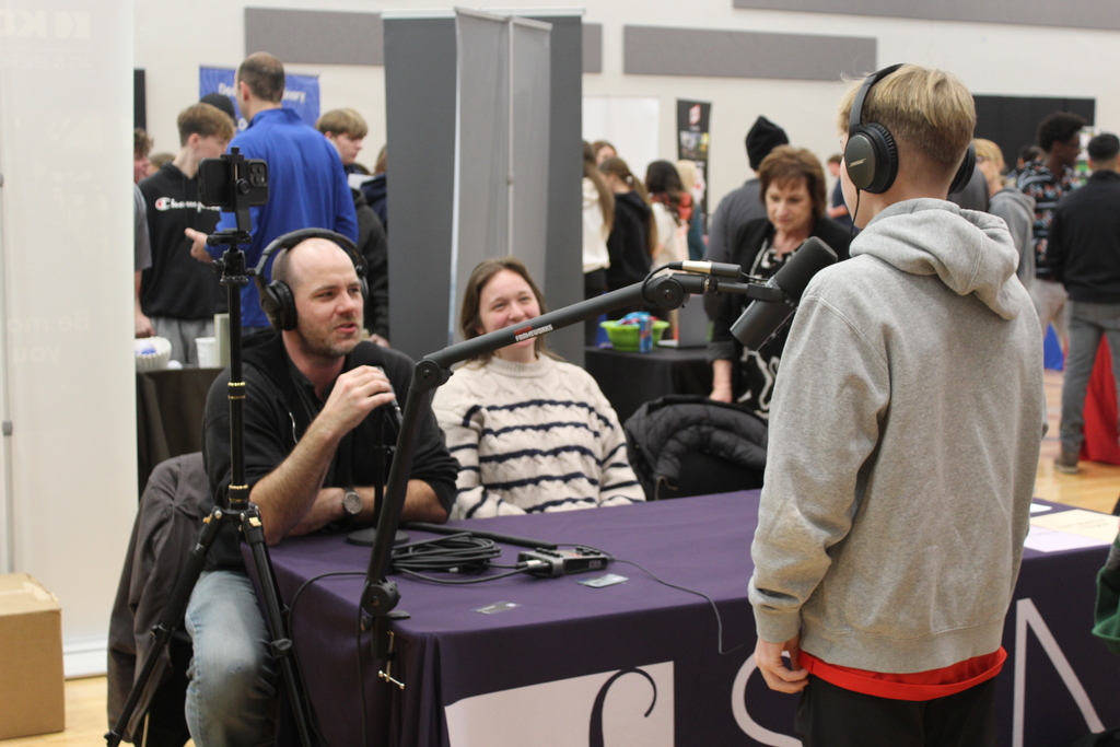 students talking to adult at career fair