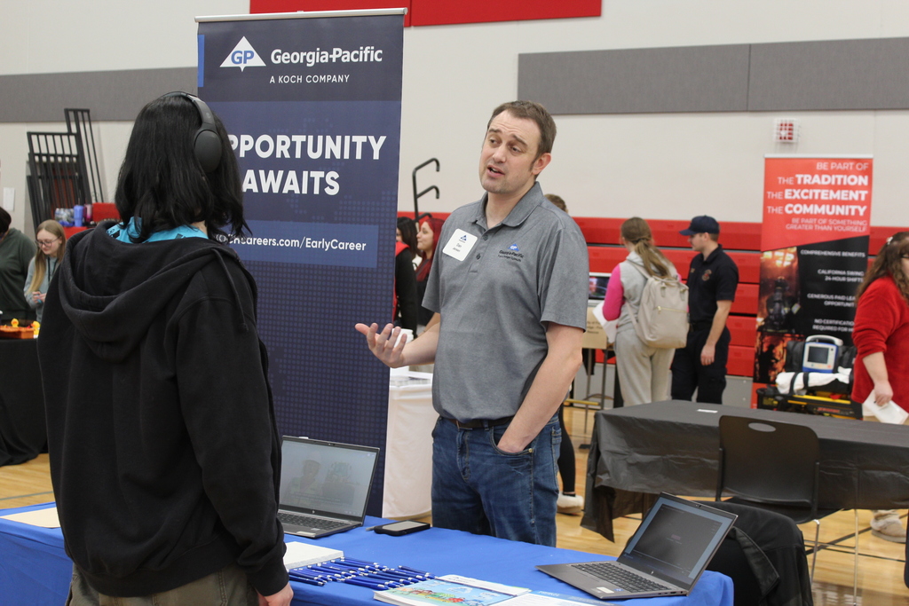 students talking to adult at career fair