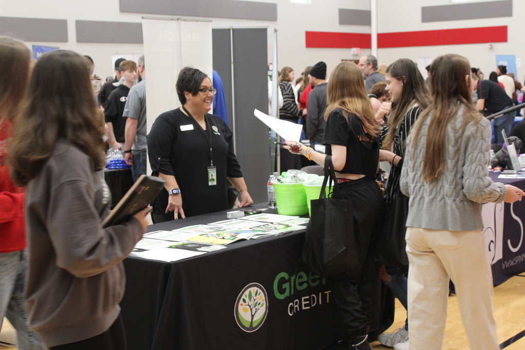 students talking to adult at career fair