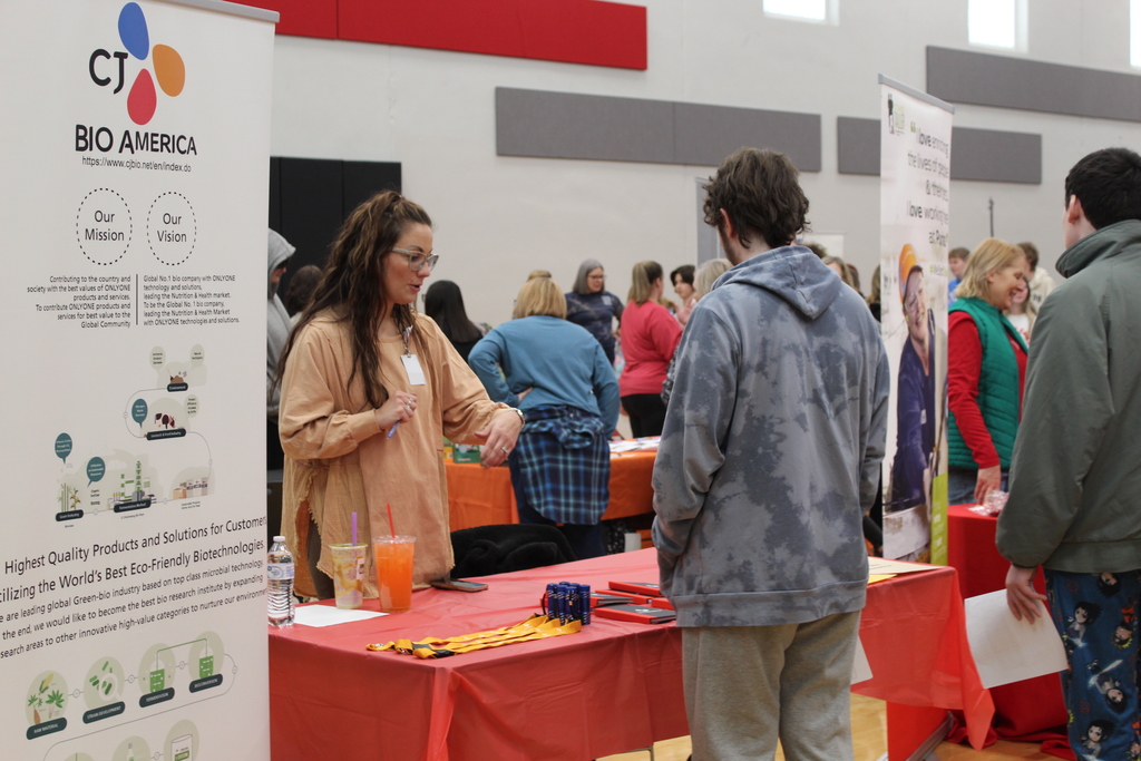 students talking to adult at career fair