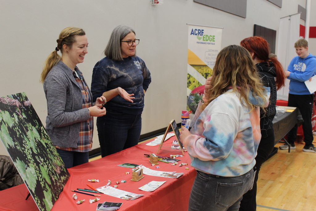 students talking to adult at career fair