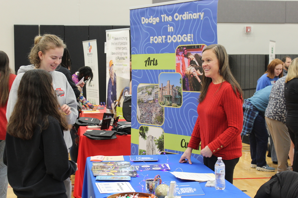 students talking to adult at career fair