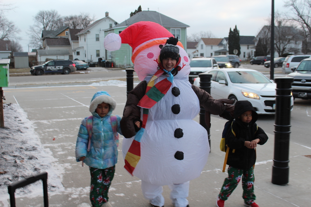 two children with adult in snowman costume