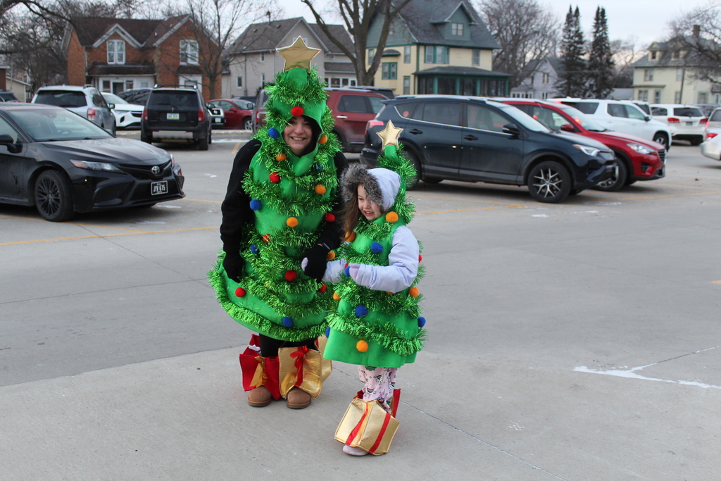 adult and child in Christmas tree costumes