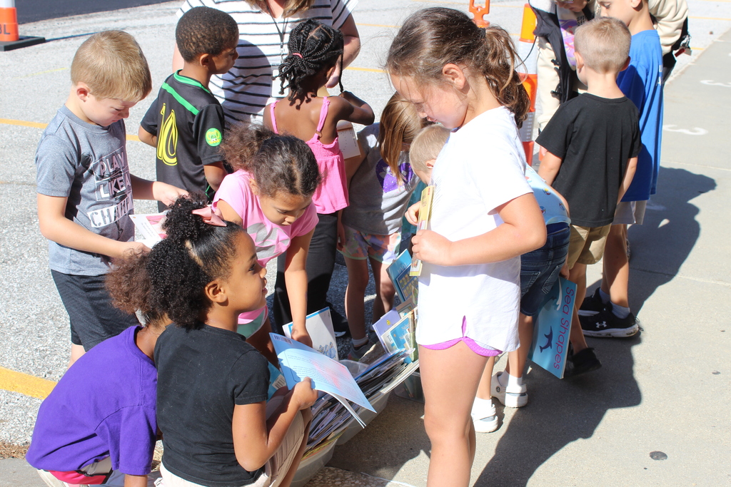 students looking at books