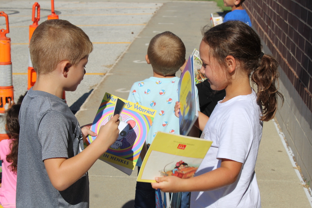 students looking at books together