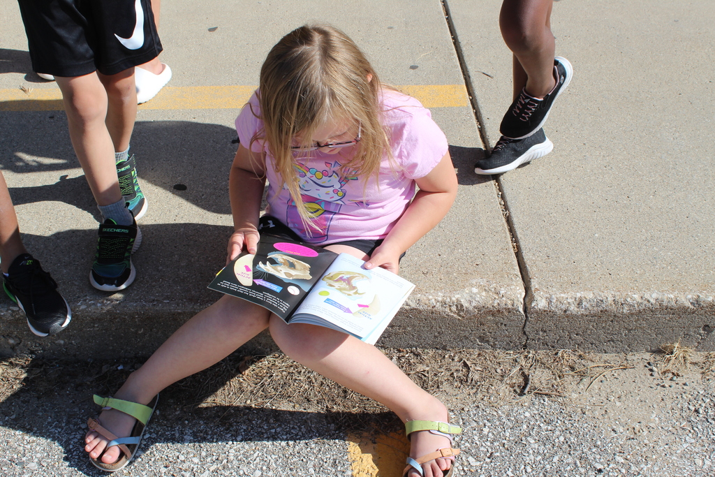 child reading a book while seated