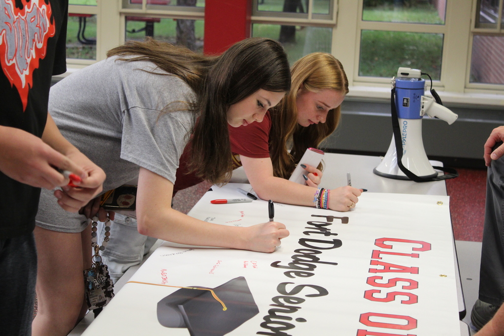 students signing paper