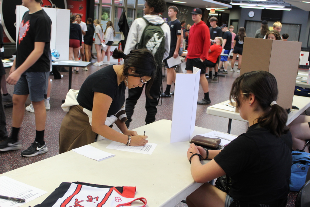 student signing paper