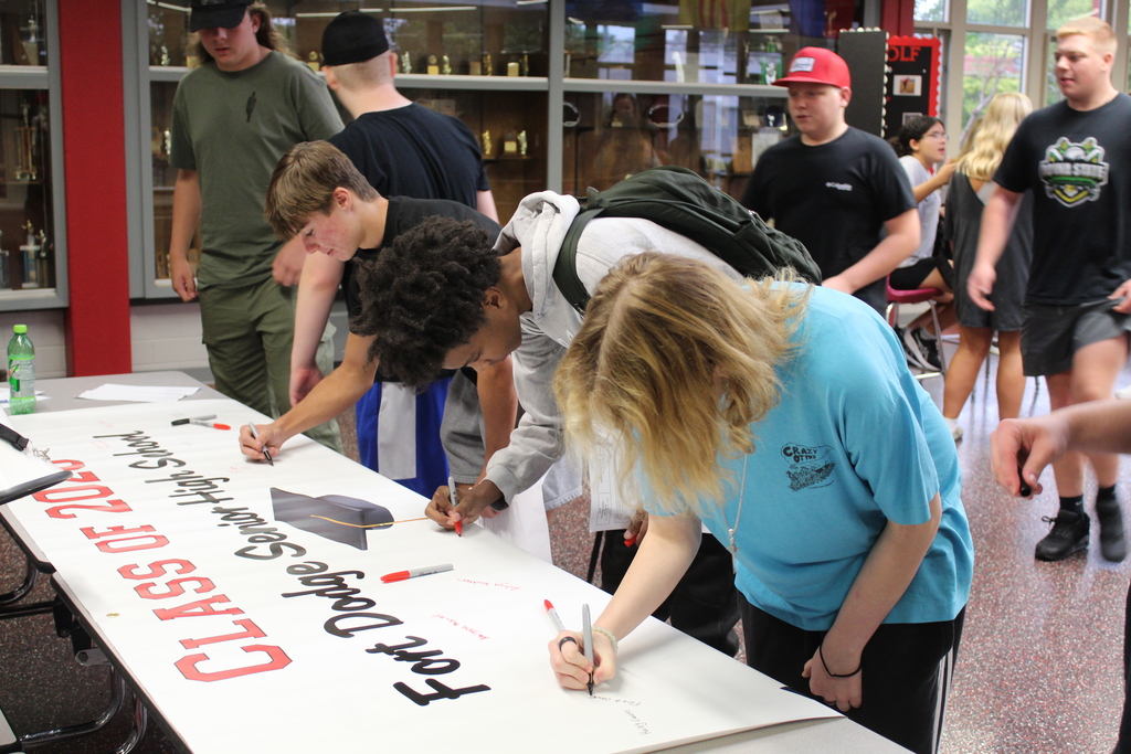 students signing paper