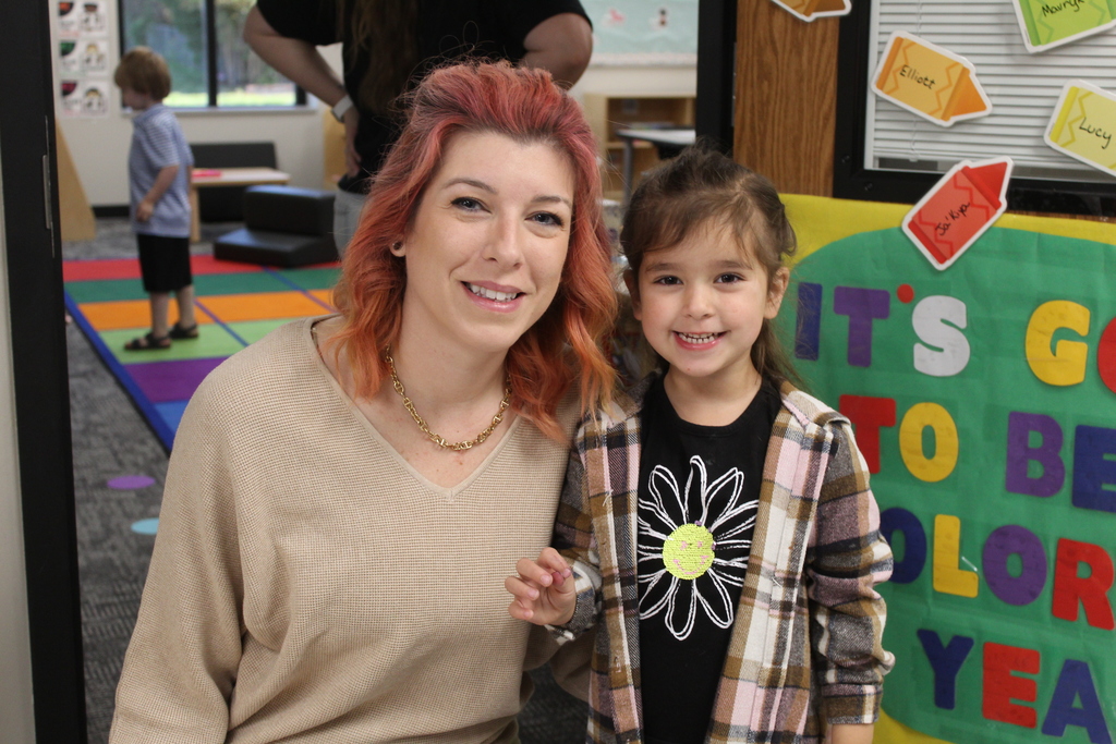 mom and daughter smiling at the camera