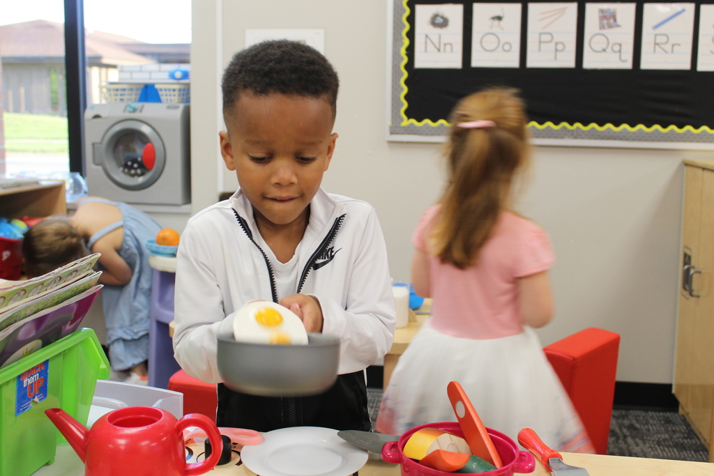 child playing in toy kitchen
