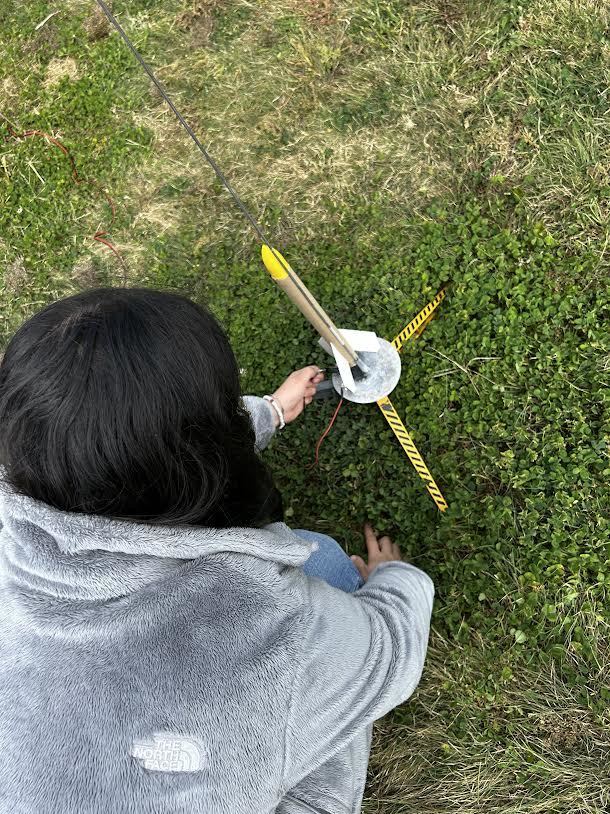 student prepares rocket for launch
