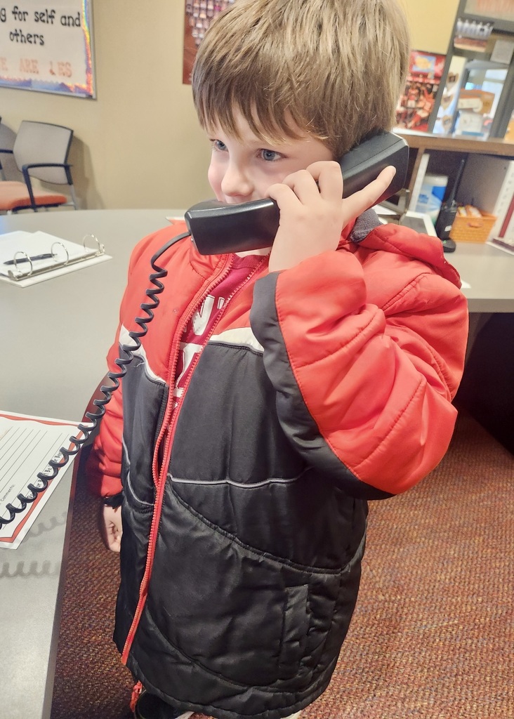 boy in the office making a good news call home