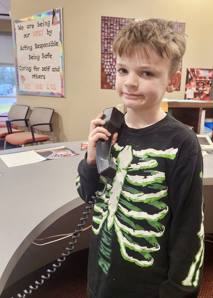boy in the office making a good news call home