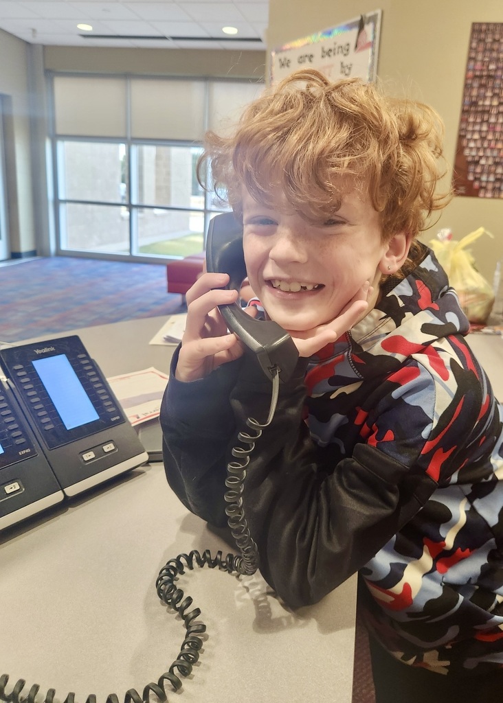 boy in the office making a good news call home