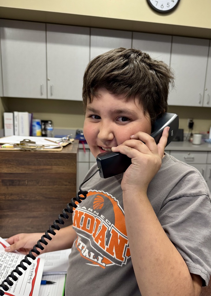 boy  in the office making a good news call home
