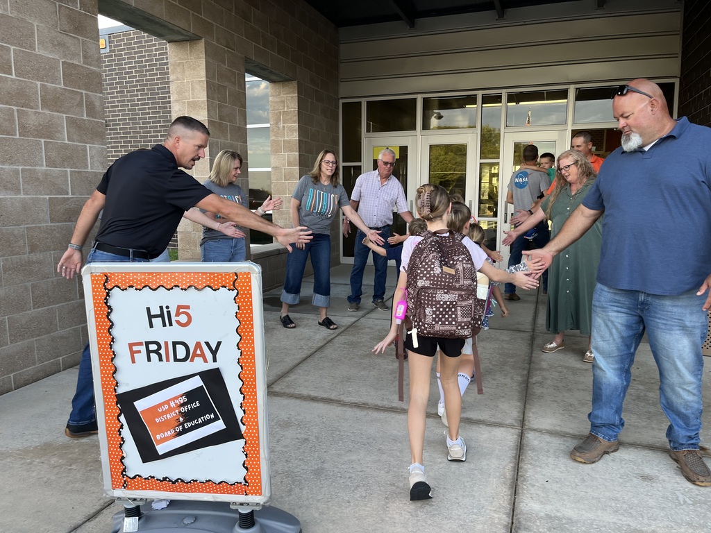 Students being welcomed to school on Hi5 Friday.