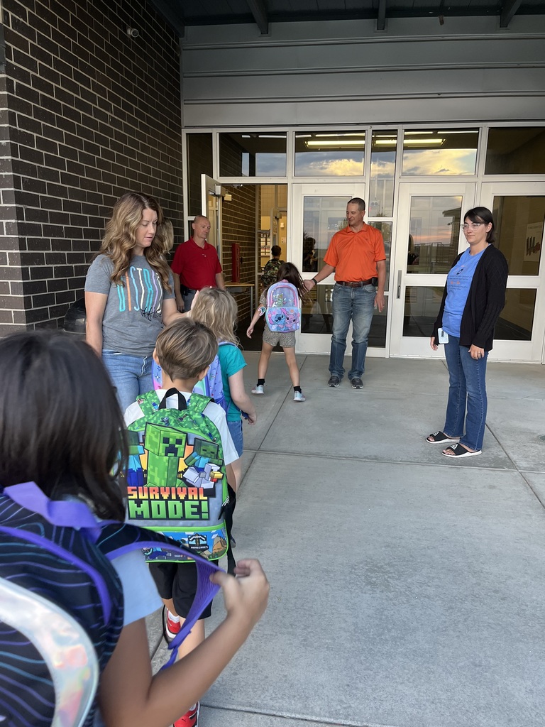 Students being welcomed to school on Hi5 Friday.