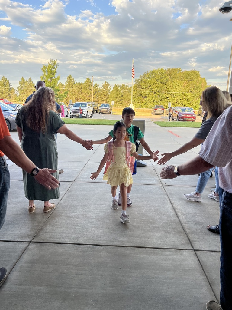 Students being welcomed to school on Hi5 Friday.