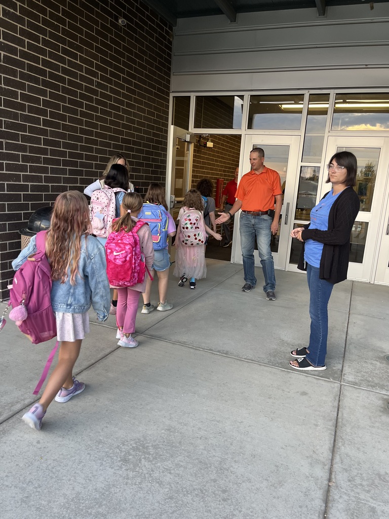 Students being welcomed to school on Hi5 Friday.