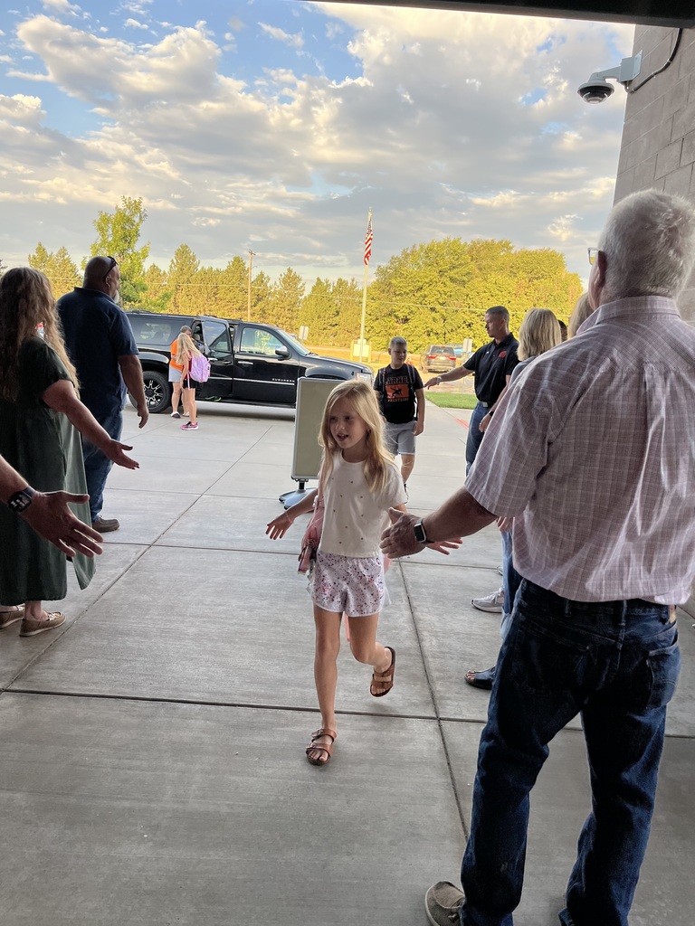 Students being welcomed to school on Hi5 Friday.