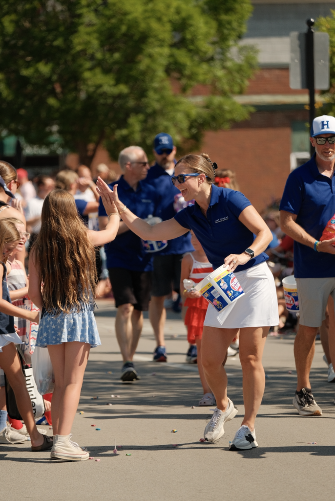 Moyer assistant principal Kara Kowalk delivers a spirited high five during the parade.