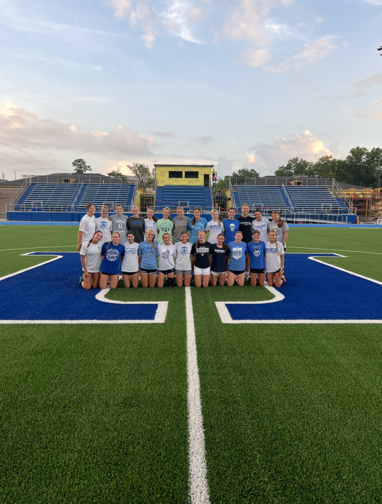 The girls soccer team took a picture on the freshly painted blue "H" at Tower Park.