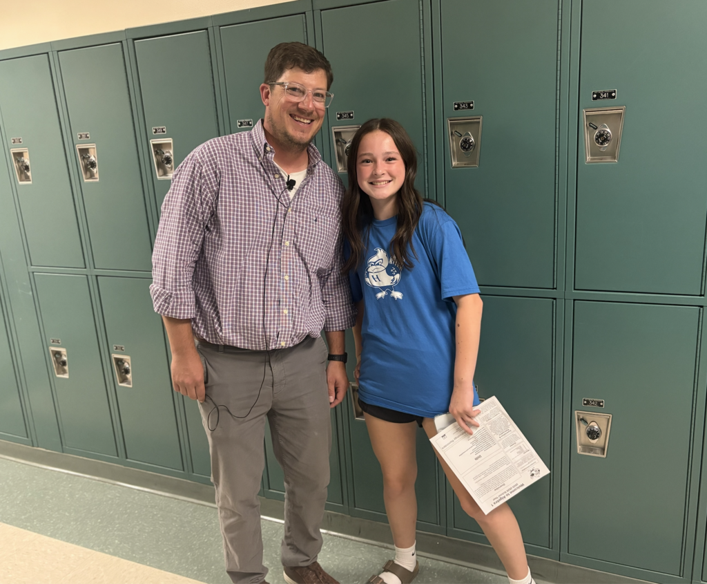Mr. Alessandro greets a student in the hallway at the Open House.