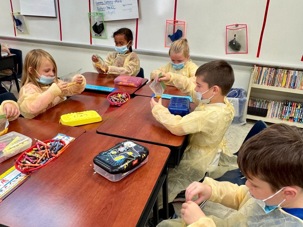 Kids dressed as doctors holding bags that represent the digestive system