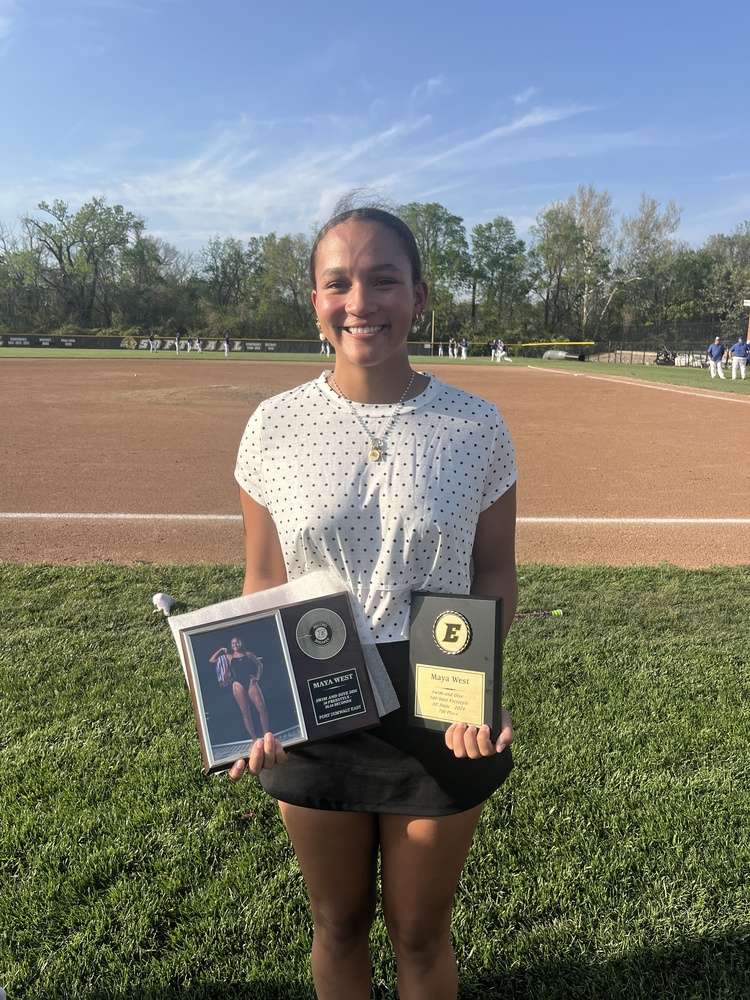 Maya West holding her record breaker plaque and all state plaque